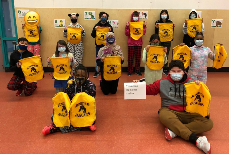 Juniper students with shelter bags.